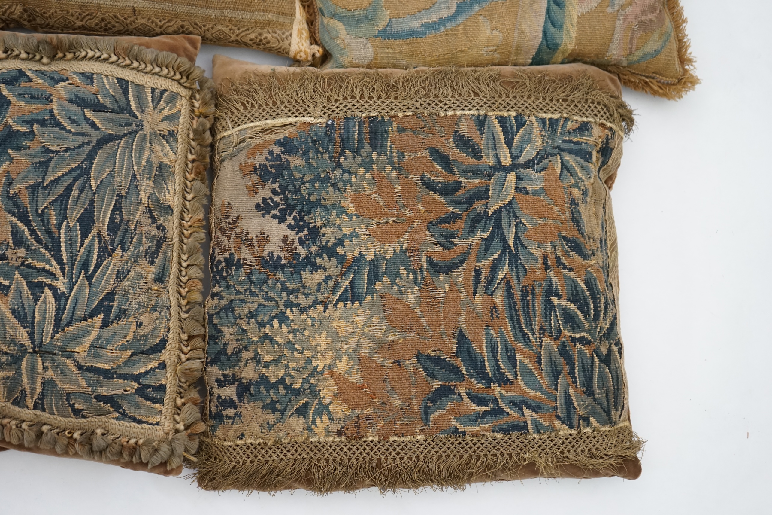 A four pairs of tapestry cushions and a similar single cushion